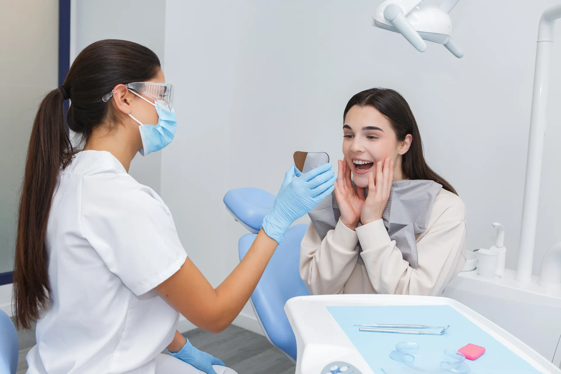 A dentist showing a patient an image of her teeth on a screen