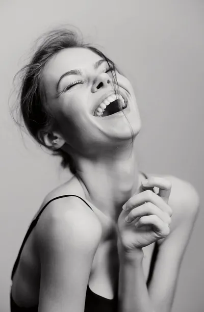 Woman laughing with her head tipped back