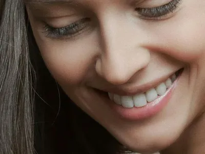 Close-up of a young woman with a soft smile
