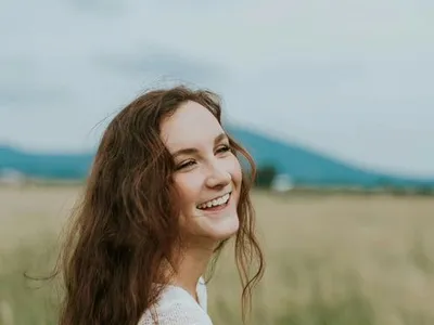A young woman laughing in natural light