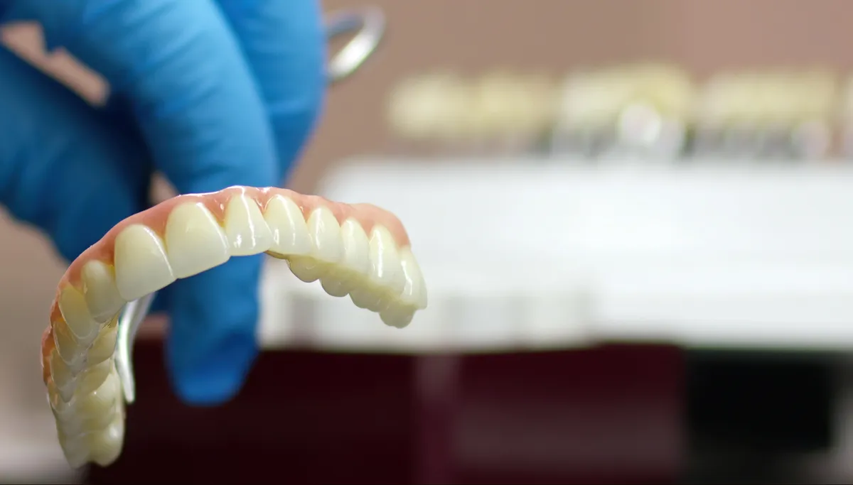 A dental crown being finished in a laboratory