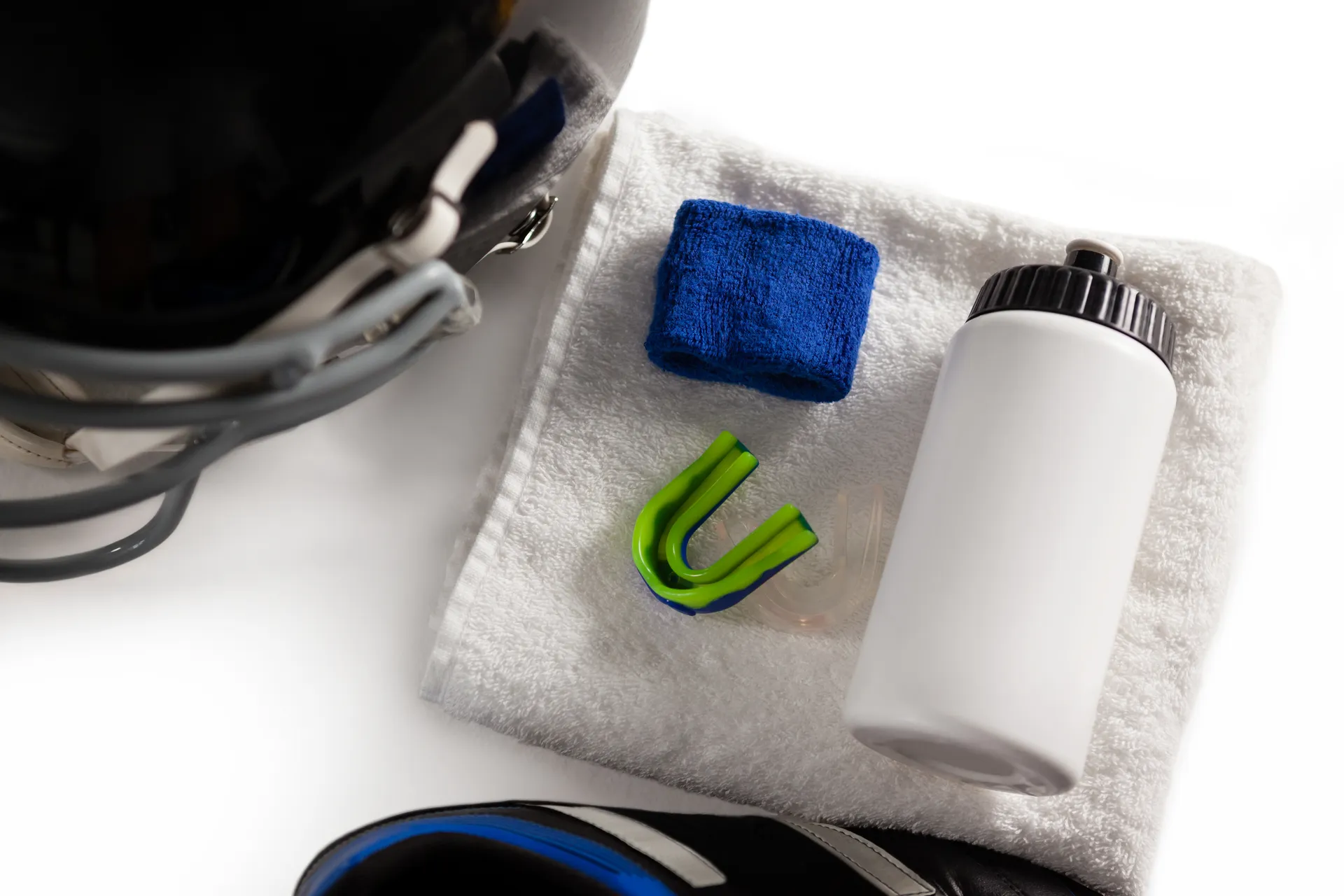 Mouthguard laid out next to a sweatband and drink bottle