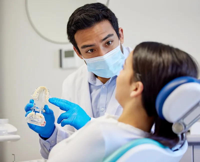 Dentist explaining a procedure to a patient before treatment