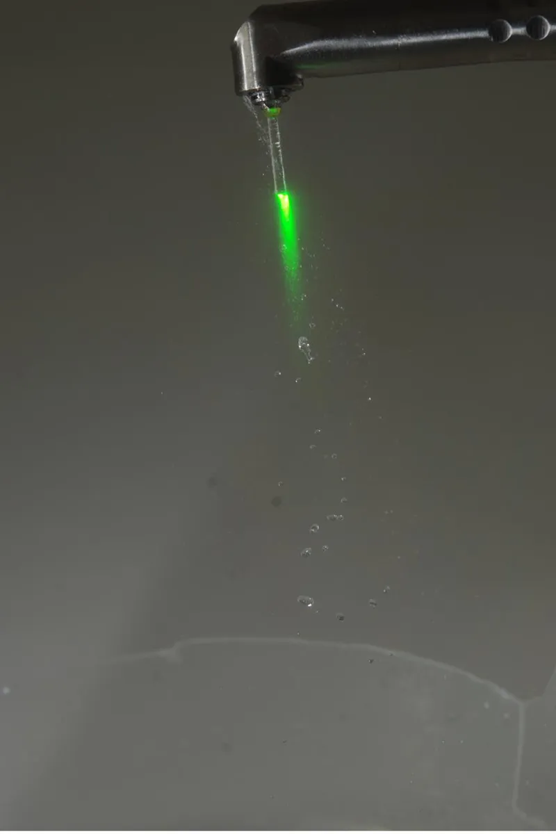Diagram of a laser pulse turning water in decayed tooth tissue into vapour