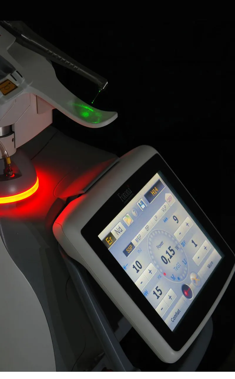 A dental laser unit with its settings shown on a control screen