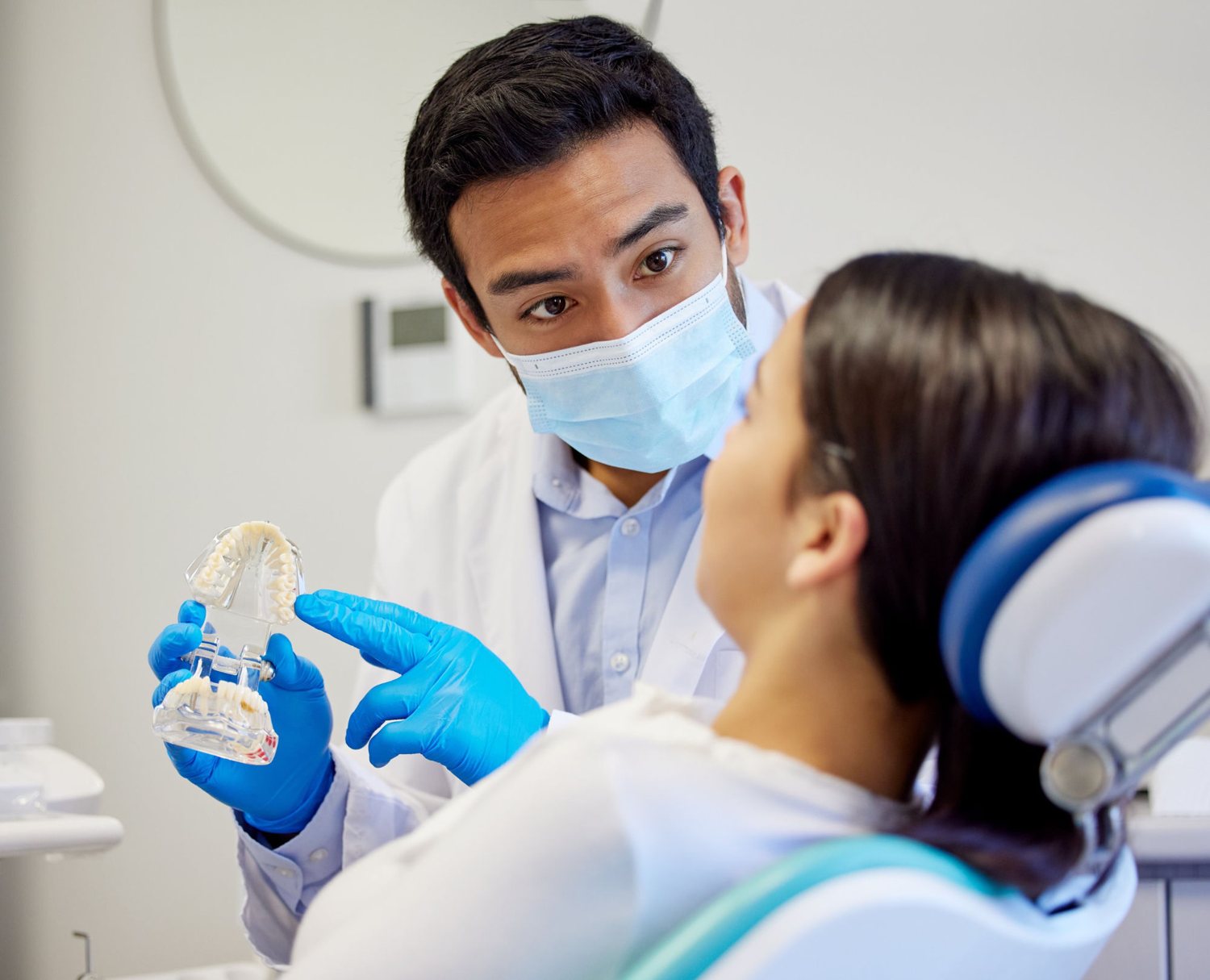 A dentist explaining a treatment plan calmly to a new patient